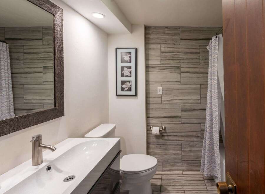 Step into this beautifully designed bathroom, featuring modern fixtures and a stylish aesthetic.