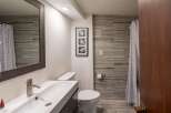Step into this beautifully designed bathroom, featuring modern fixtures and a stylish aesthetic.