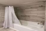 Step into a beautifully designed bathroom featuring a modern shower with a stylish curtain.