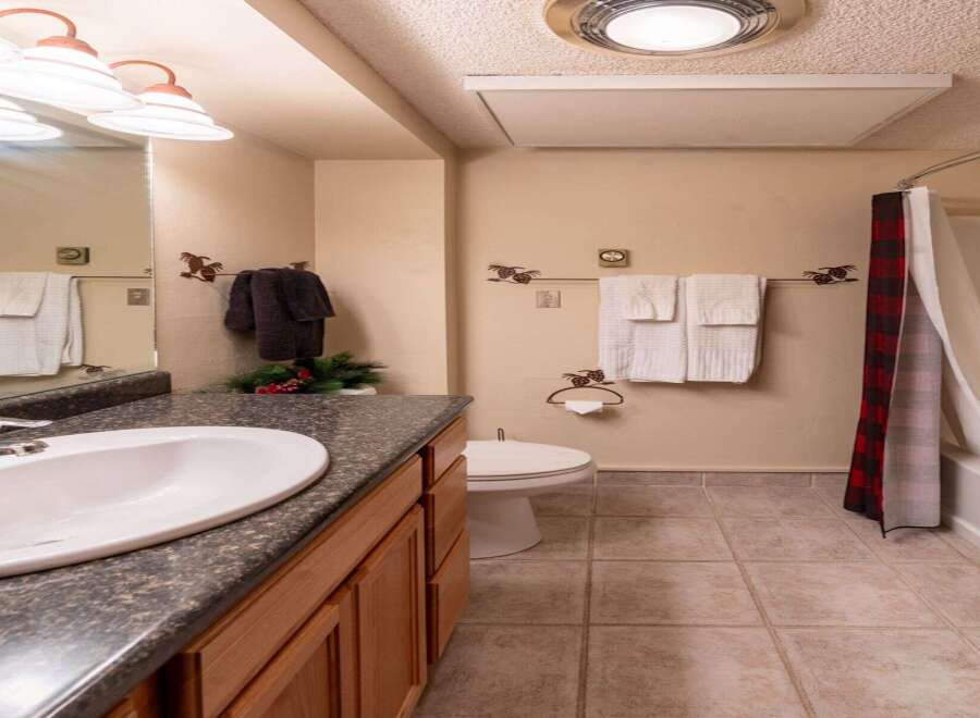 This charming bathroom features a classic design with a touch of rustic elegance.
