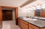 This bathroom features a stylish vanity with ample storage, perfect for keeping your essentials organized.