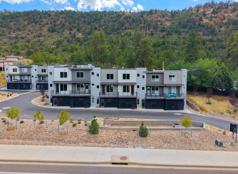 Discover modern living in this stunning townhouse development nestled against a scenic hillside.