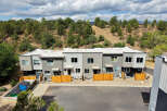 Discover modern living in this stunning townhouse complex, nestled against a scenic hillside.