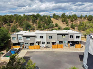 Discover modern living in this stunning townhouse complex, nestled against a scenic hillside.