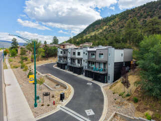 Discover modern living in this stunning townhome community nestled against a scenic hillside.