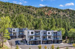 Discover modern living in this stunning townhome development nestled against a lush, tree-covered mountainside.