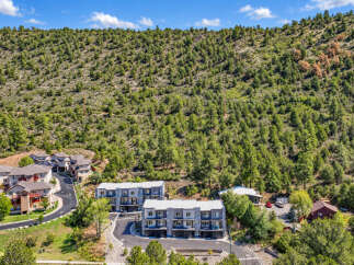 Discover modern living nestled against a backdrop of lush green hills.