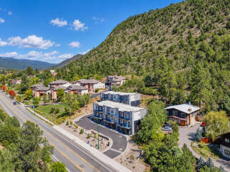Discover modern living nestled against a scenic mountain backdrop.