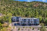 Discover modern living in this stunning townhouse development nestled against a lush, tree-covered hillside.