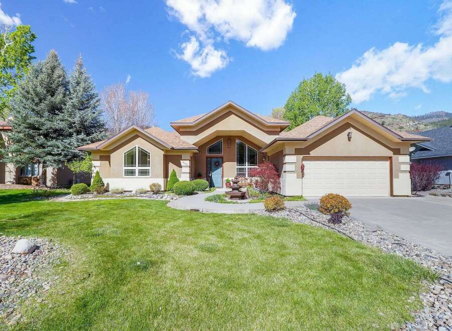 This stunning property boasts a beautifully landscaped front yard and a charming exterior.