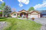 This stunning property boasts a beautifully landscaped front yard and a charming exterior.