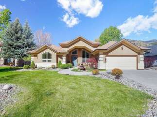 This stunning property boasts a beautifully landscaped front yard and a charming exterior.