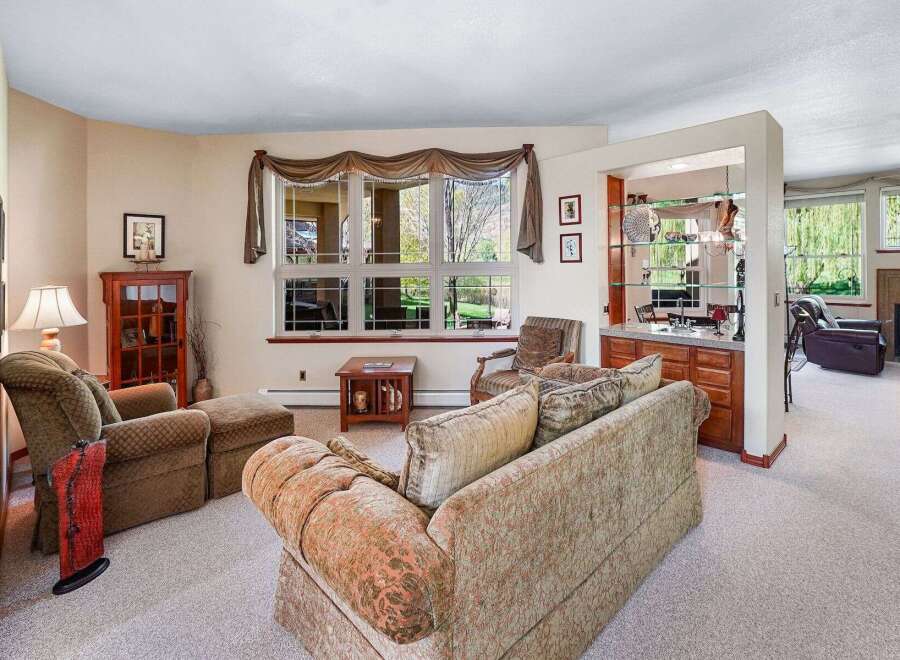 This inviting living space offers a cozy atmosphere with its plush seating and warm color palette.