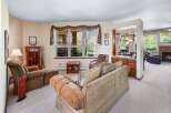 This inviting living space offers a cozy atmosphere with its plush seating and warm color palette.