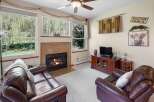 Cozy up in this inviting living room, featuring a warm fireplace and comfortable leather seating.