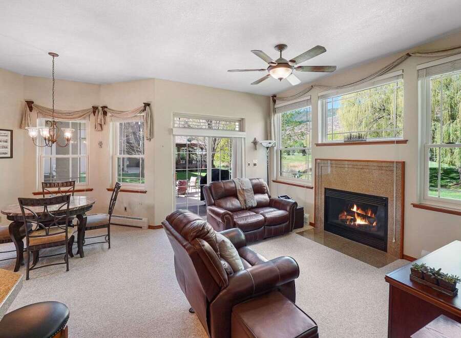 This stunning property boasts a cozy living room with a fireplace, perfect for relaxing evenings.
