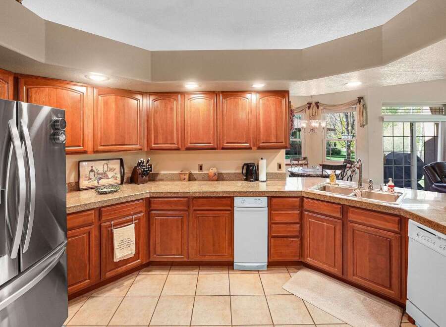 This stunning kitchen boasts beautiful wooden cabinetry and countertops, creating a warm and inviting atmosphere.