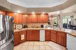 This stunning kitchen boasts beautiful wooden cabinetry and countertops, creating a warm and inviting atmosphere.