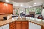 This stunning kitchen boasts beautiful wooden cabinetry and granite countertops, creating a warm and inviting atmosphere.