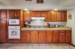 This kitchen boasts beautiful wooden cabinetry, offering ample storage space and a warm, inviting atmosphere.