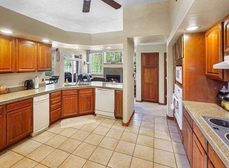 This stunning kitchen boasts beautiful wooden cabinetry and a spacious layout, perfect for both cooking and entertaining.