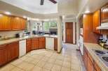 This stunning kitchen boasts beautiful wooden cabinetry and a spacious layout, perfect for both cooking and entertaining.
