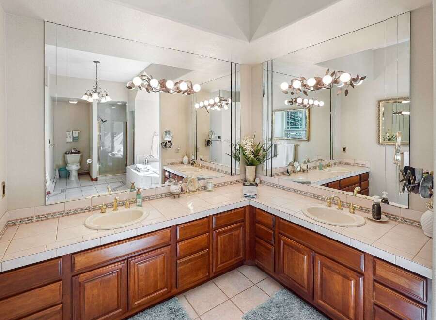 Step into luxury with this stunning bathroom featuring a spacious vanity area.