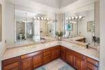 Step into luxury with this stunning bathroom featuring a spacious vanity area.