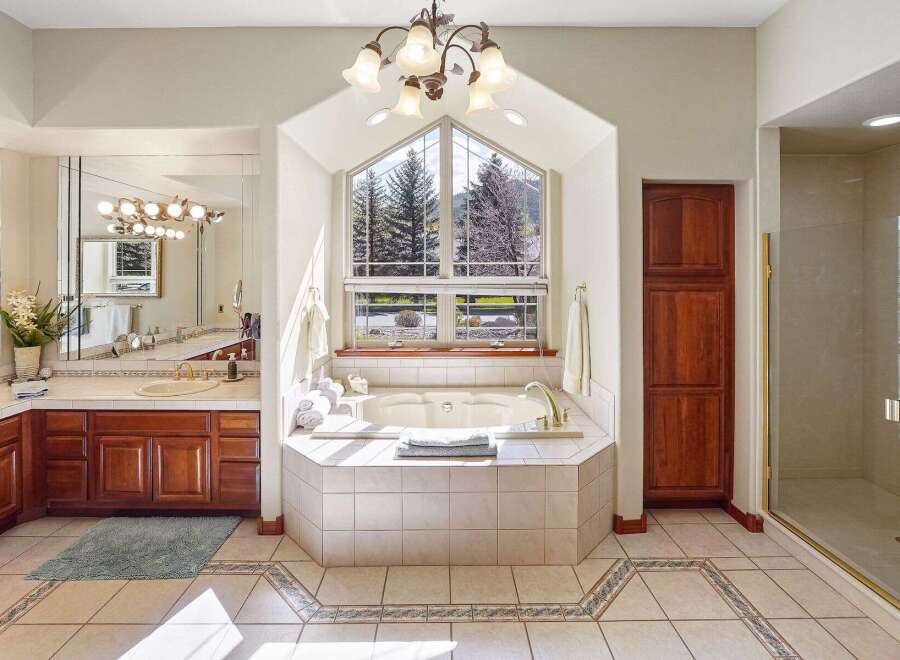 This luxurious bathroom boasts a stunning design with a large soaking tub, perfect for relaxation.