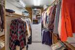 Step into your dream closet! This spacious walk-in closet offers ample storage with built-in shelving and drawers, perfect for organizing your wardrobe.