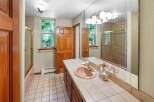 Step into this inviting bathroom featuring a stylish vanity with a unique pink sink.