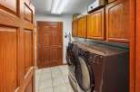Step into this inviting laundry room, featuring a modern washer and dryer set.