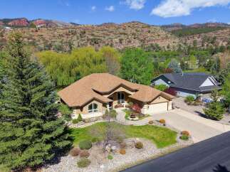 This stunning property boasts a beautifully designed home with a warm, inviting aesthetic.