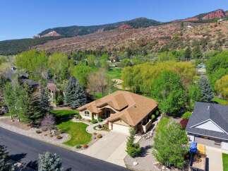 Discover a stunning home nestled in a picturesque setting, offering breathtaking views of the surrounding mountains and lush greenery.