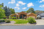 Discover this stunning home featuring a warm stucco exterior and a welcoming entryway with a vibrant blue door.