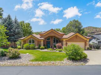 Discover this stunning home featuring a warm stucco exterior and a welcoming entryway with a vibrant blue door.