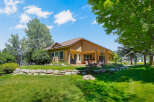 Enjoy outdoor living with this spacious backyard featuring a covered patio, perfect for entertaining.