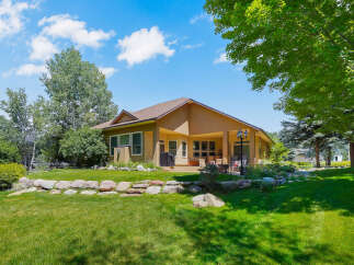 Enjoy outdoor living with this spacious backyard featuring a covered patio, perfect for entertaining.