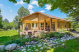 Enjoy outdoor living in this stunning backyard featuring a spacious patio with a fire pit and comfortable seating, perfect for gatherings.