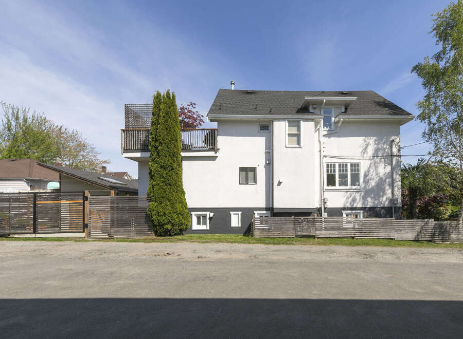 This stunning property boasts a modern design with a crisp white exterior and a charming balcony.