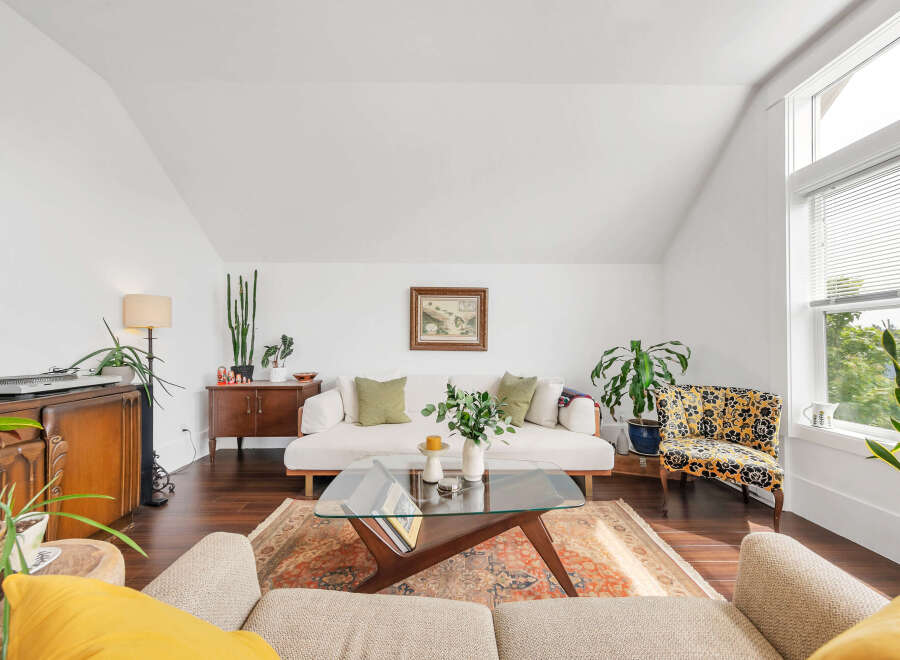 This stunning living room boasts a bright and airy atmosphere with its vaulted ceilings and ample natural light.