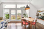 This charming dining area features a bright and airy atmosphere, perfect for enjoying meals and gatherings.