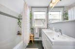 This charming bathroom features a modern design with a touch of nature.