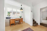 This bright and airy home office features a large window that floods the space with natural light.