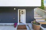 This charming home boasts a welcoming entrance with a stylish front door and a cozy doormat.