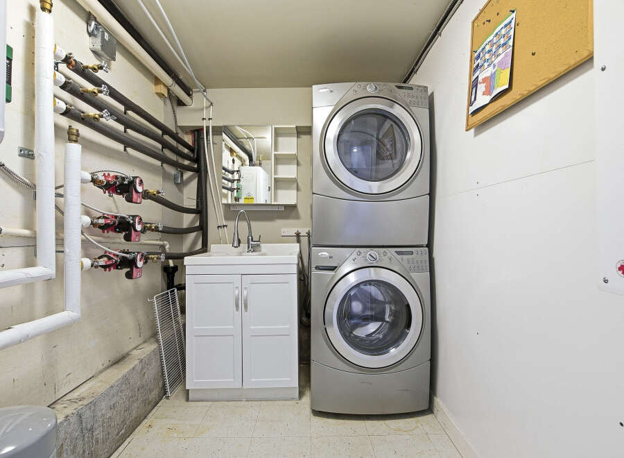 This utility room features a modern stacked washer and dryer, perfect for efficient laundry days.