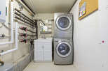 This utility room features a modern stacked washer and dryer, perfect for efficient laundry days.
