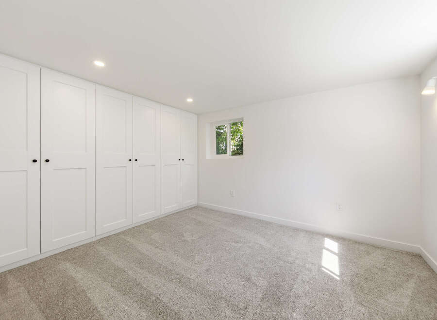 Discover the elegance of this bright and airy room, featuring pristine white walls and ample storage with built-in closets.