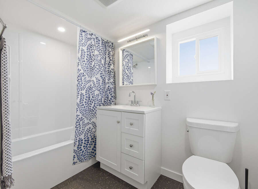 This bright and modern bathroom features a clean, minimalist design.