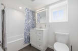 This bright and modern bathroom features a clean, minimalist design.